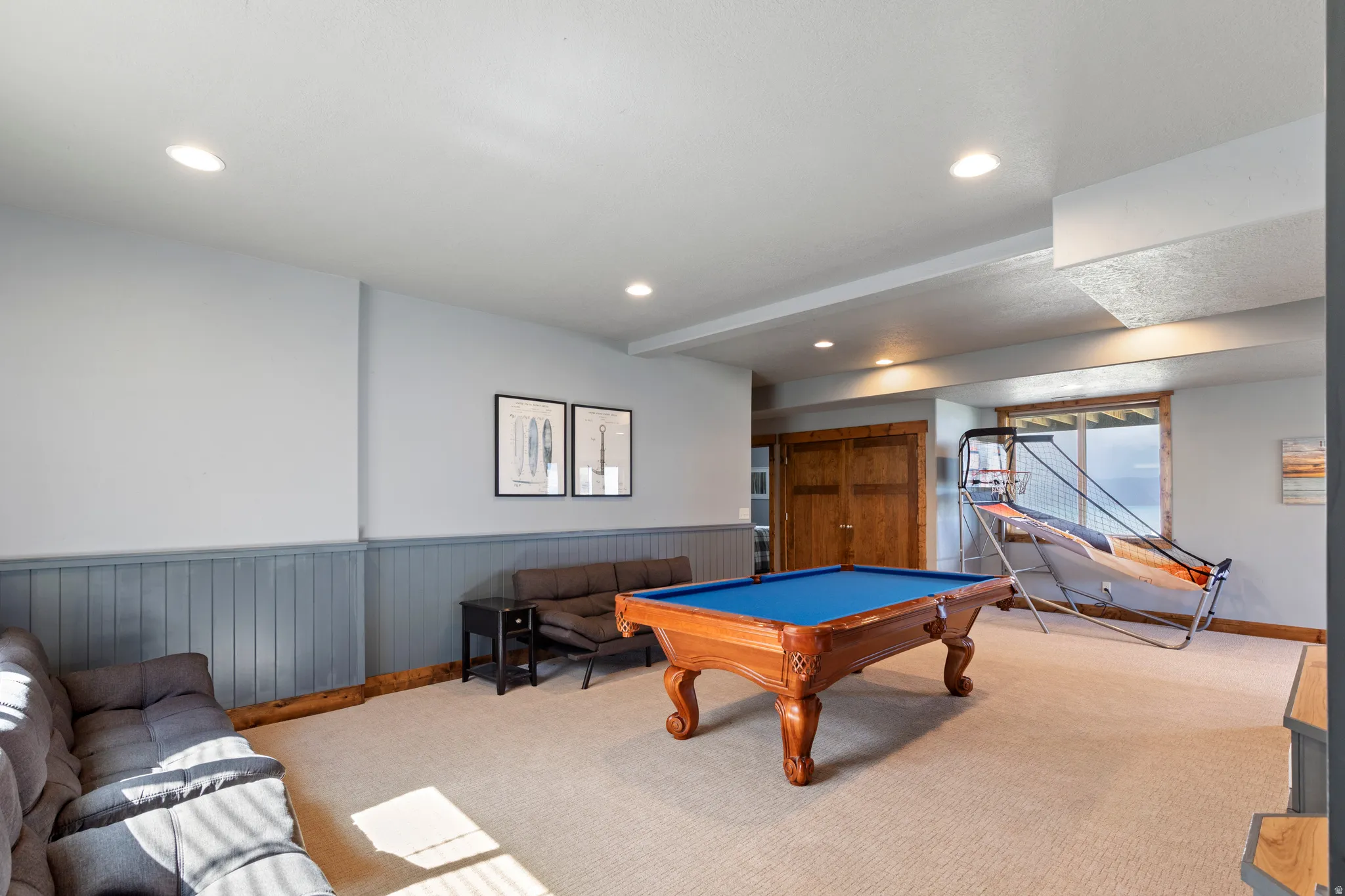 Versatile recreation room featuring carpet flooring, recessed lighting, and wainscoting