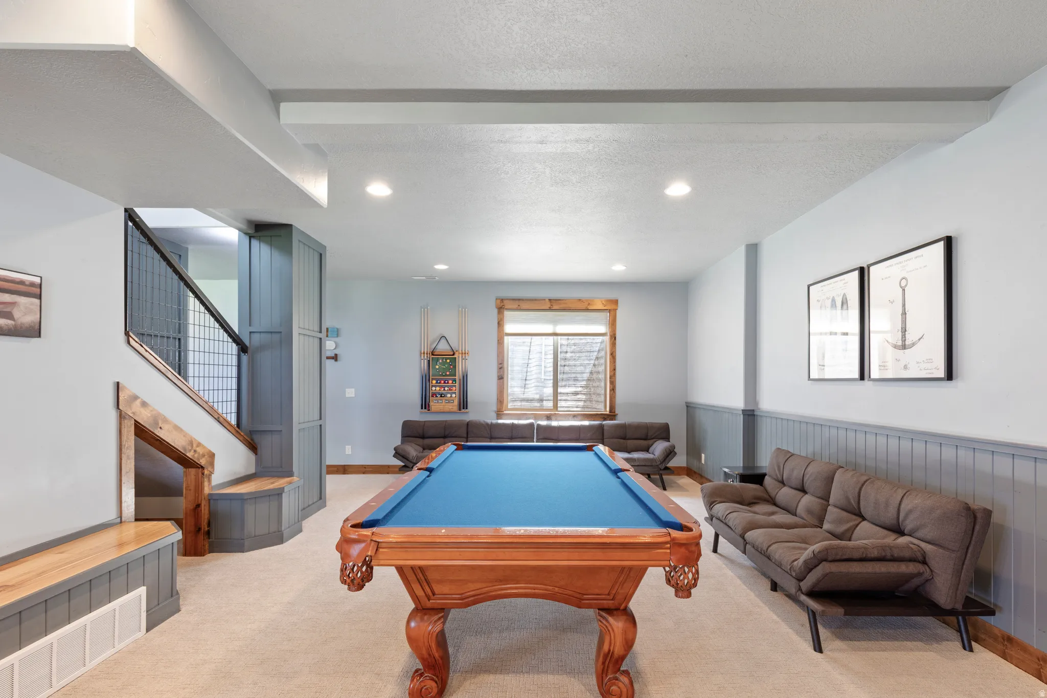 Spacious recreational area featuring recessed lighting, a neutral carpet, and a wood-trimmed window