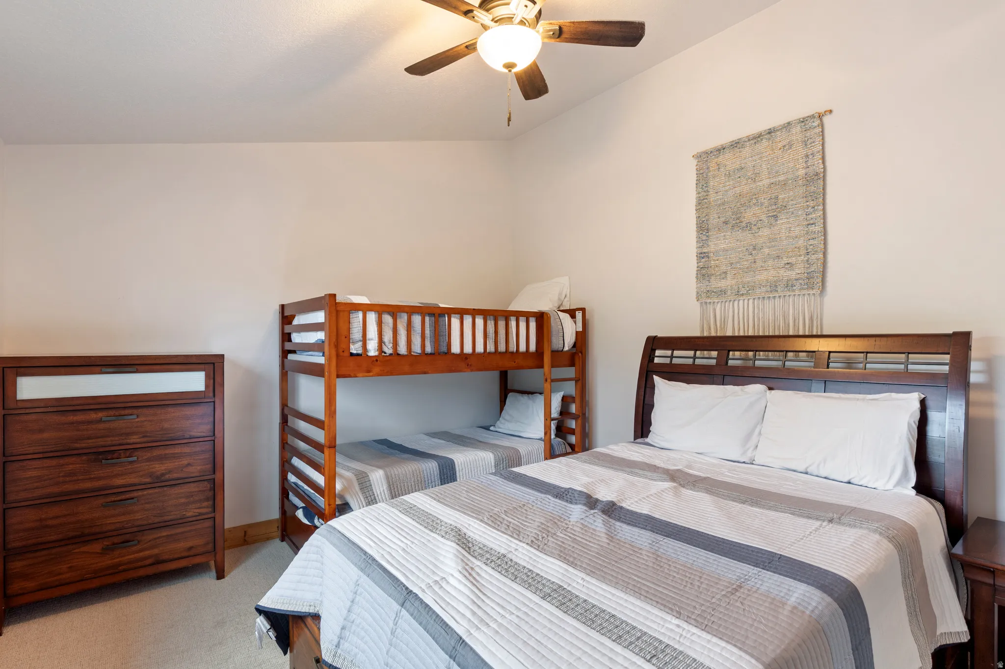Bedroom featuring light-toned walls and carpeted flooring