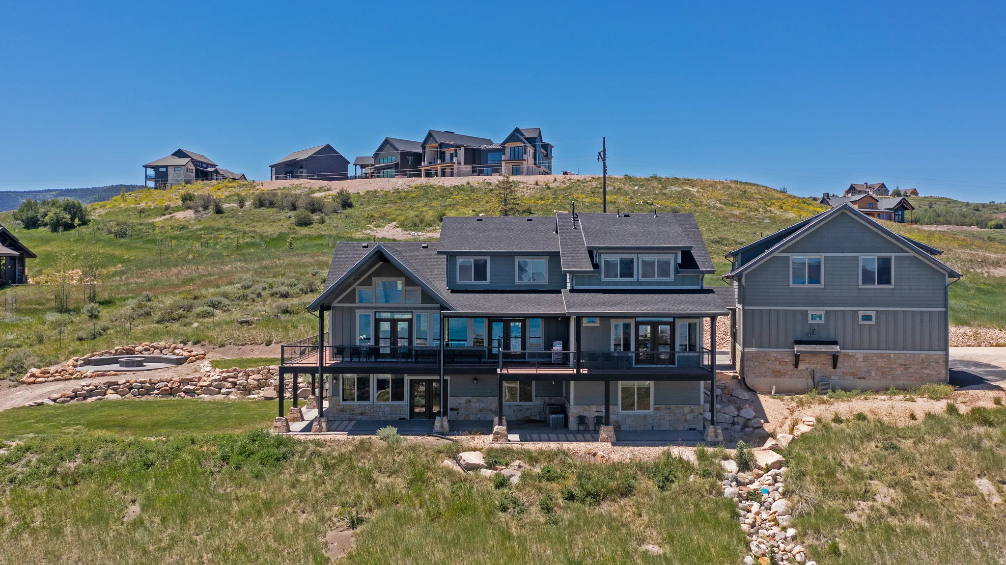 Contemporary multi-story residence featuring a stone and siding exterior