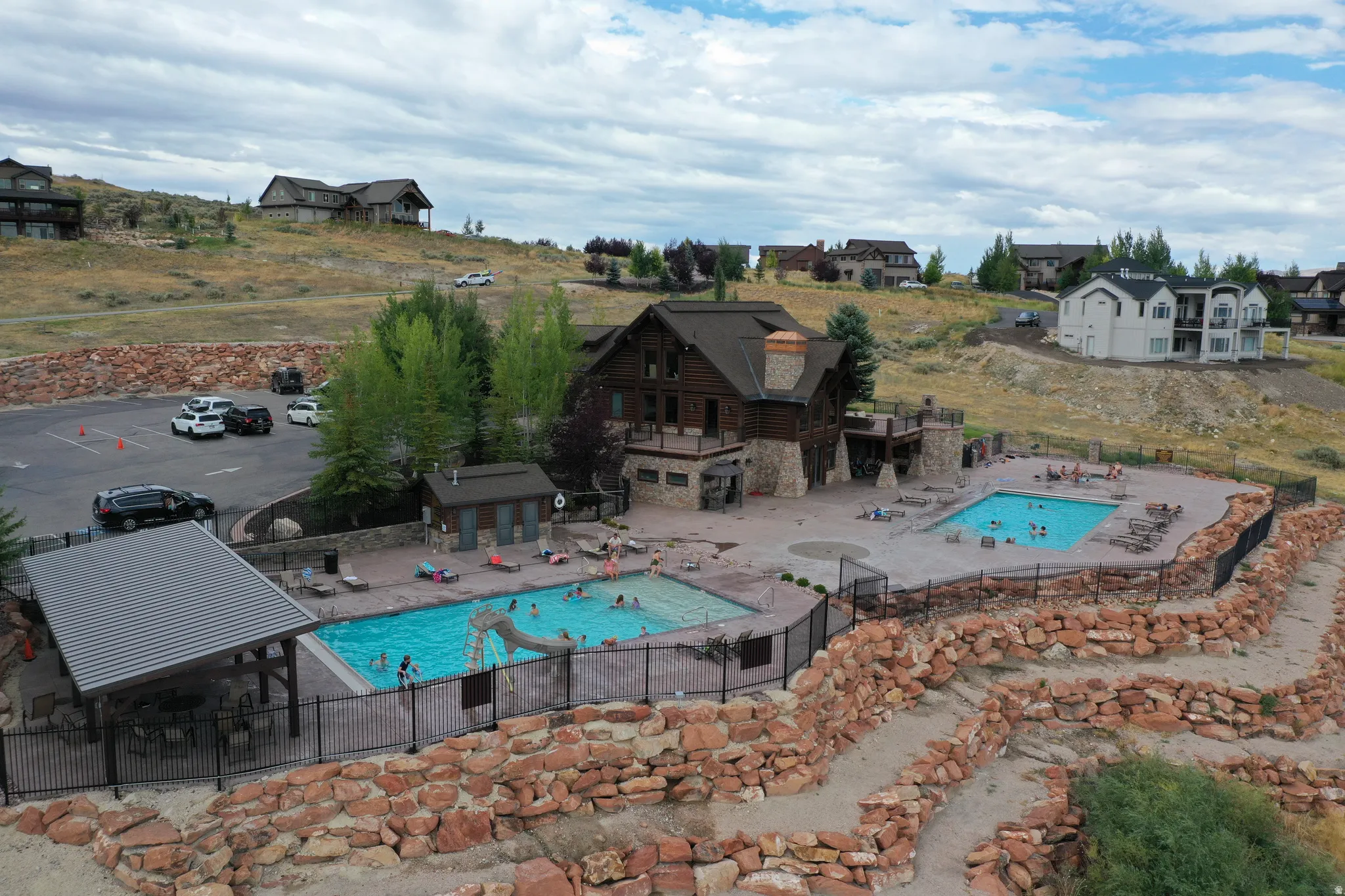 Community recreation area featuring a large central building with extensive stone and wood construction