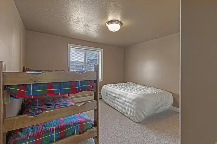 Room featuring light brown walls and neutral-toned carpeting