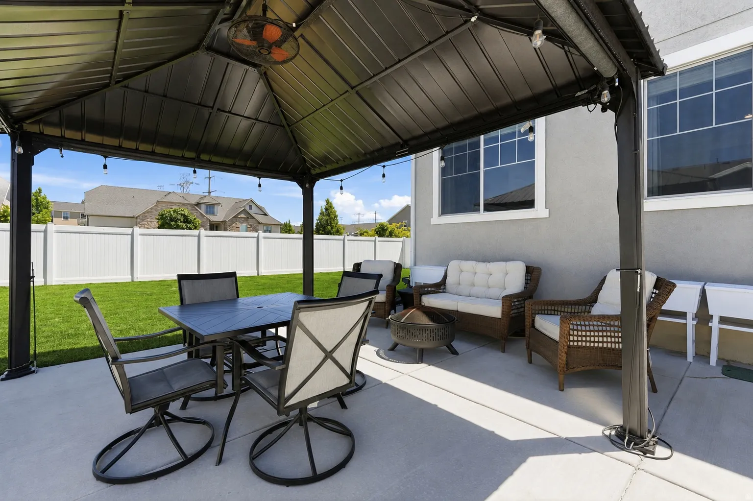 Patio featuring a gazebo with a ceiling fan and a concrete surface