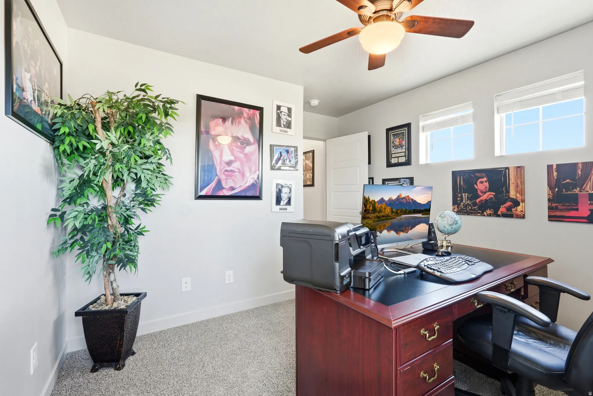 Bedroom featuring light gray carpeting, neutral wall paint, and a ceiling fan with light fixture
