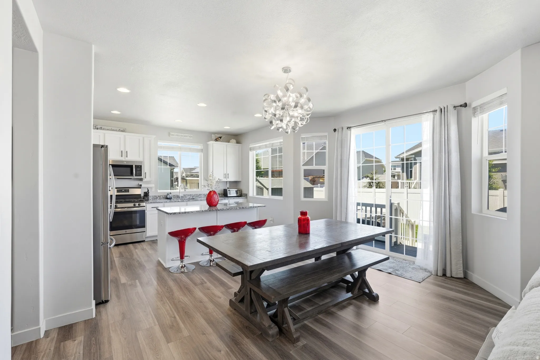 Open-concept kitchen and dining area featuring light wood-finish flooring