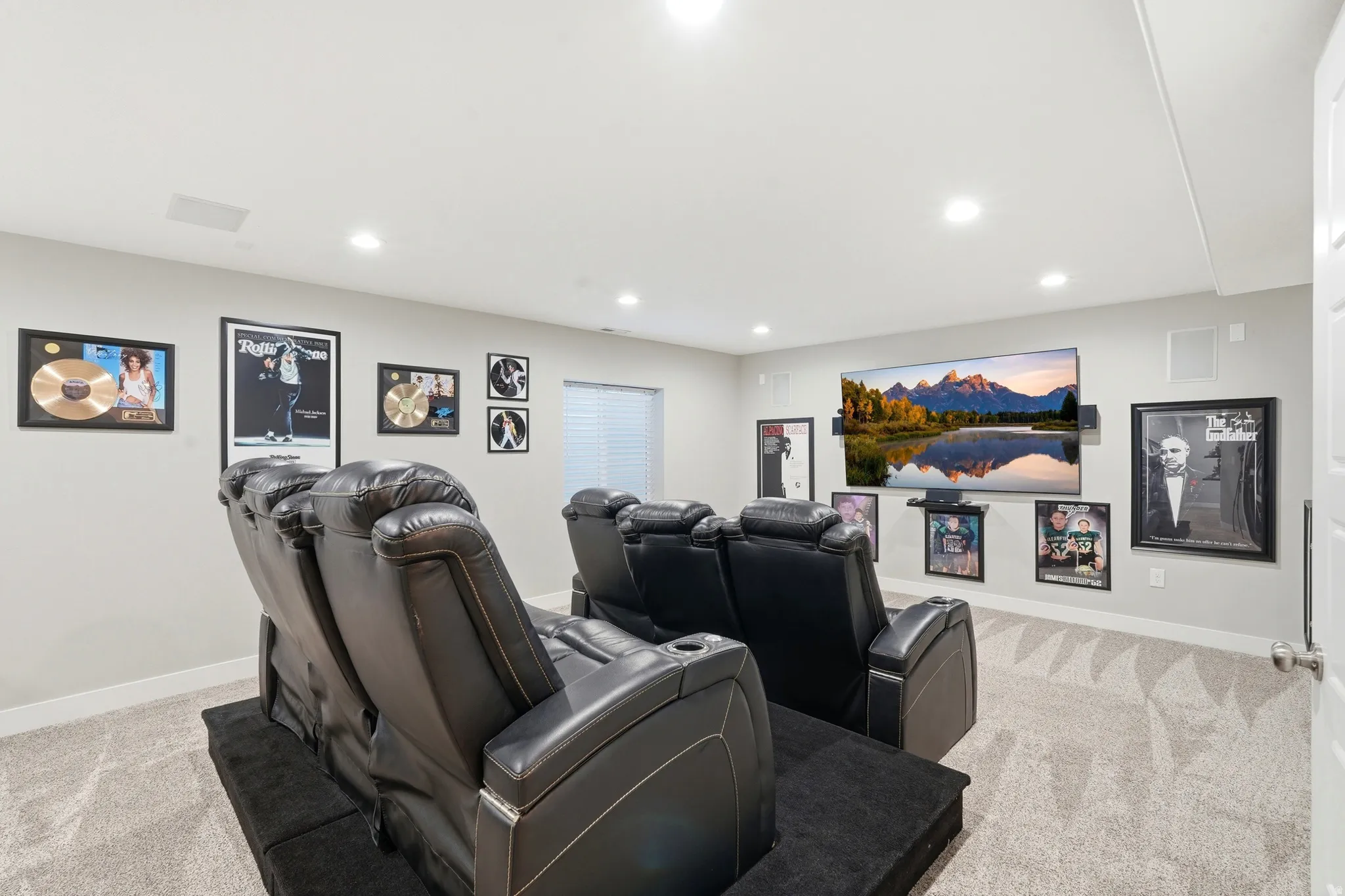 Dedicated media room featuring recessed lighting, light-colored walls and light-toned carpet flooring