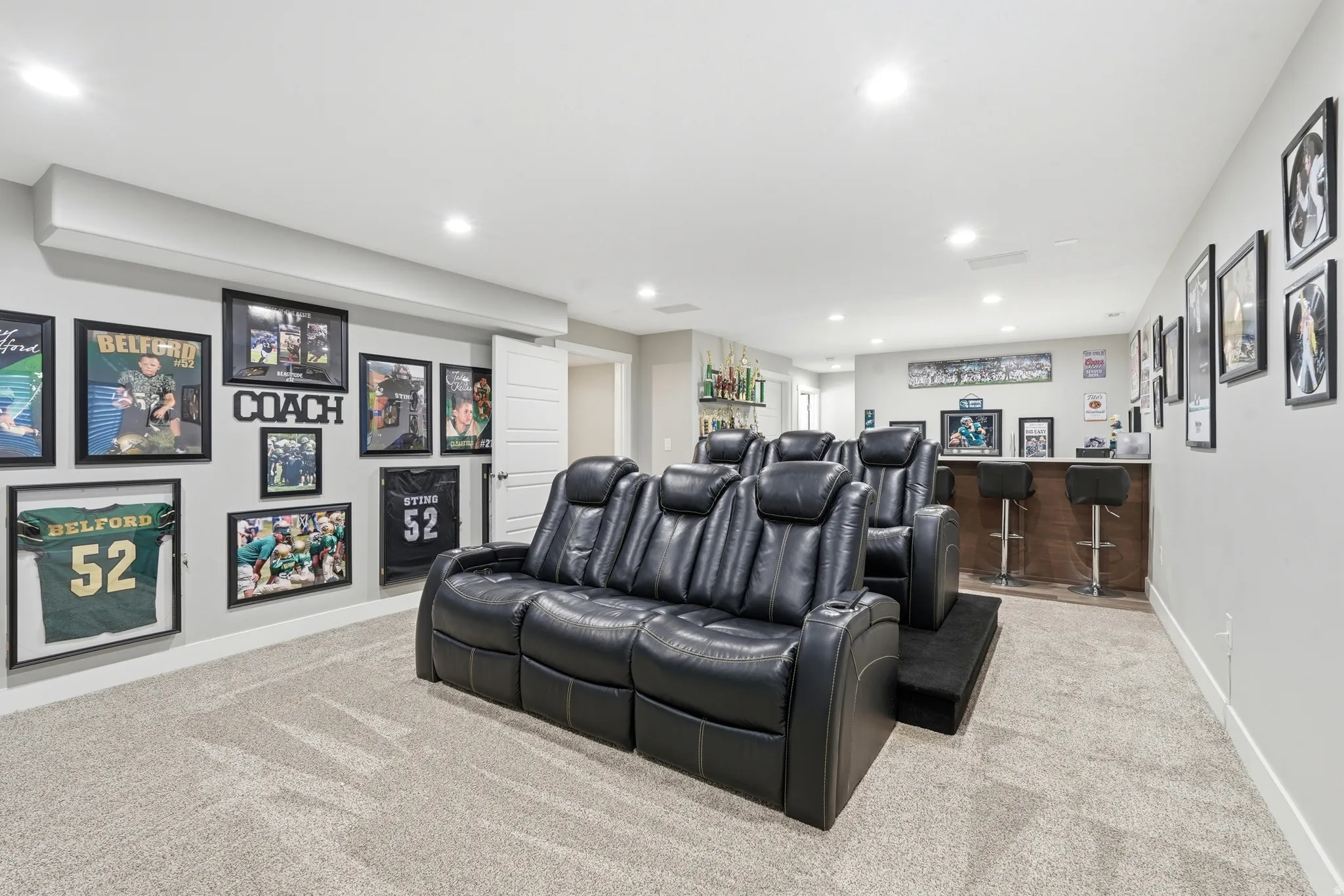Spacious recreation room featuring recessed lighting and light-toned carpeting