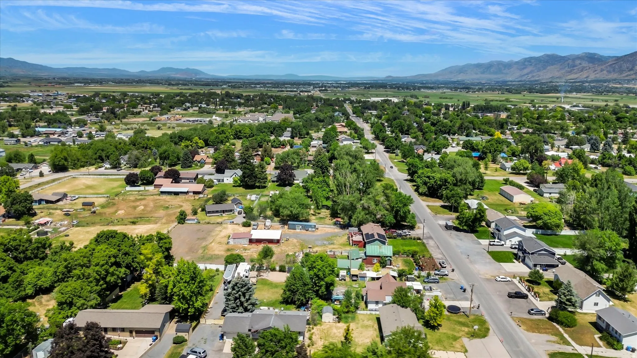 Expansive aerial perspective showcasing a residential district with a clear sky and distant mountain range