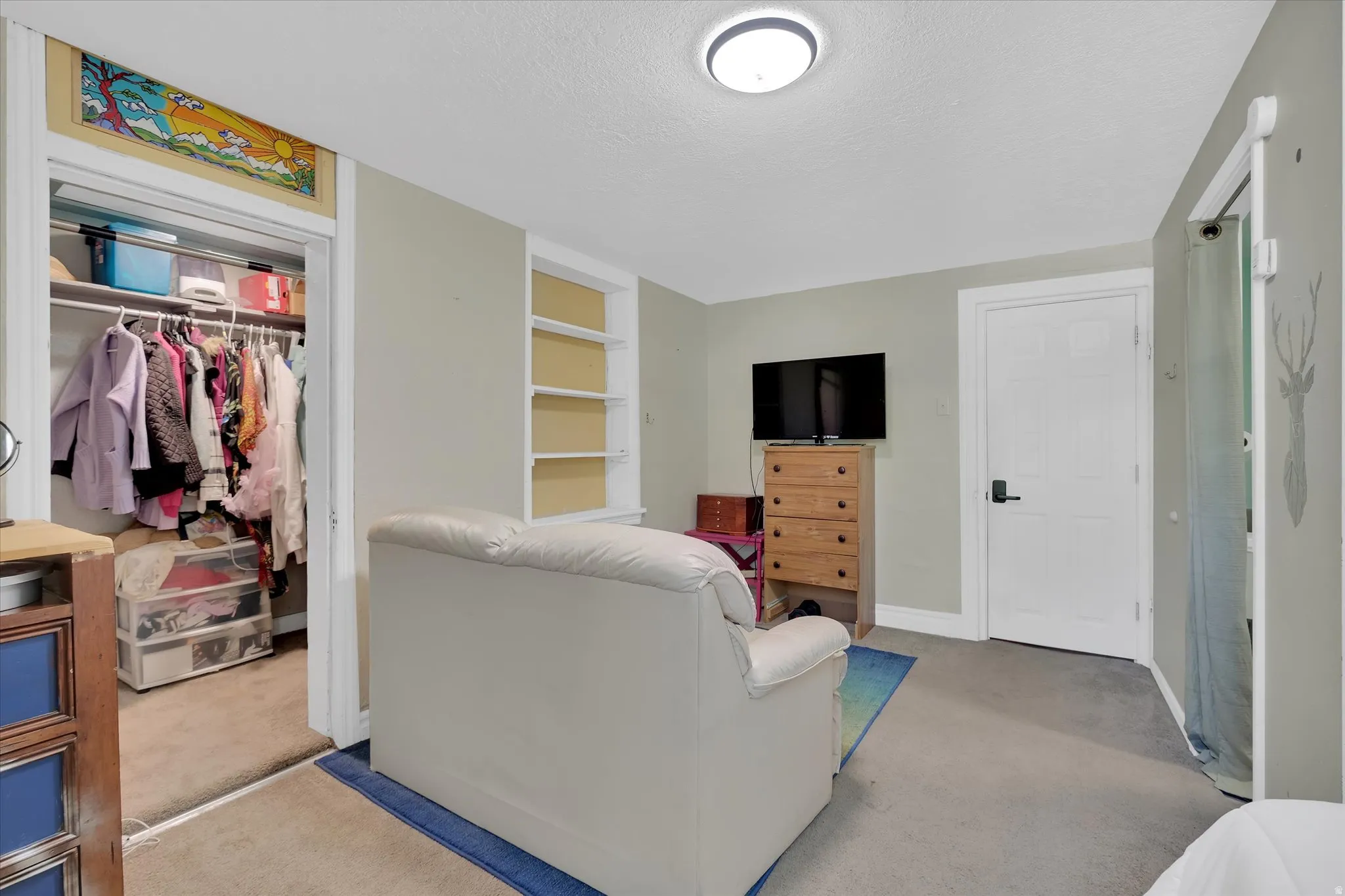 Interior space featuring neutral wall tones and carpeted flooring