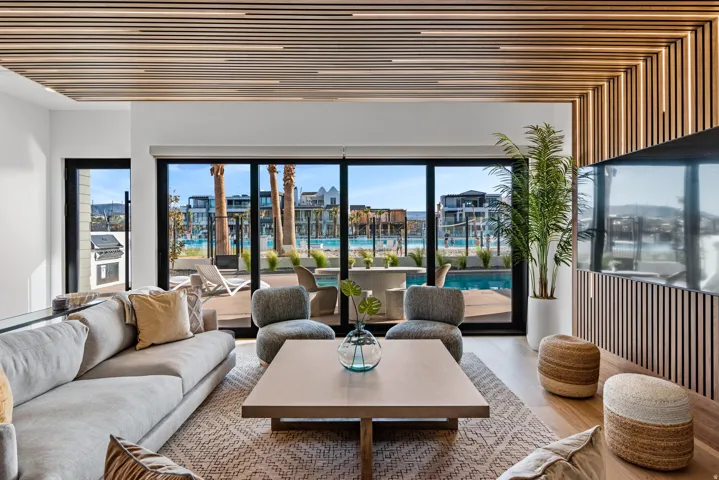 Open concept living area featuring wood-finish flooring and a slatted wood ceiling