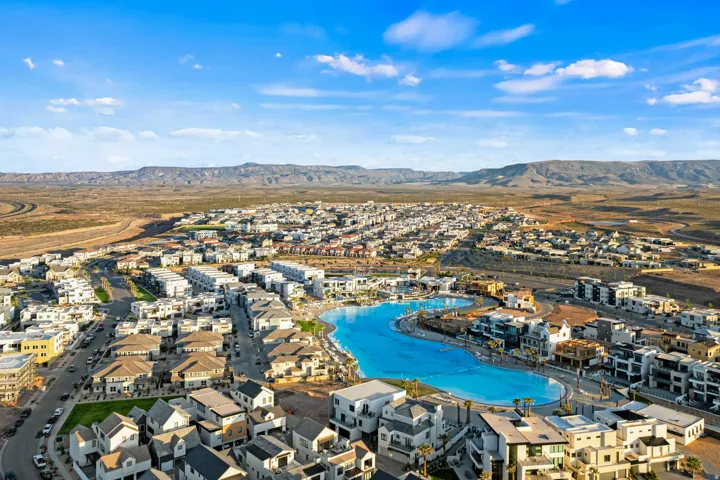 Aerial overview showcasing a developed community with extensive residential properties and a large, multi-section recreational lagoon