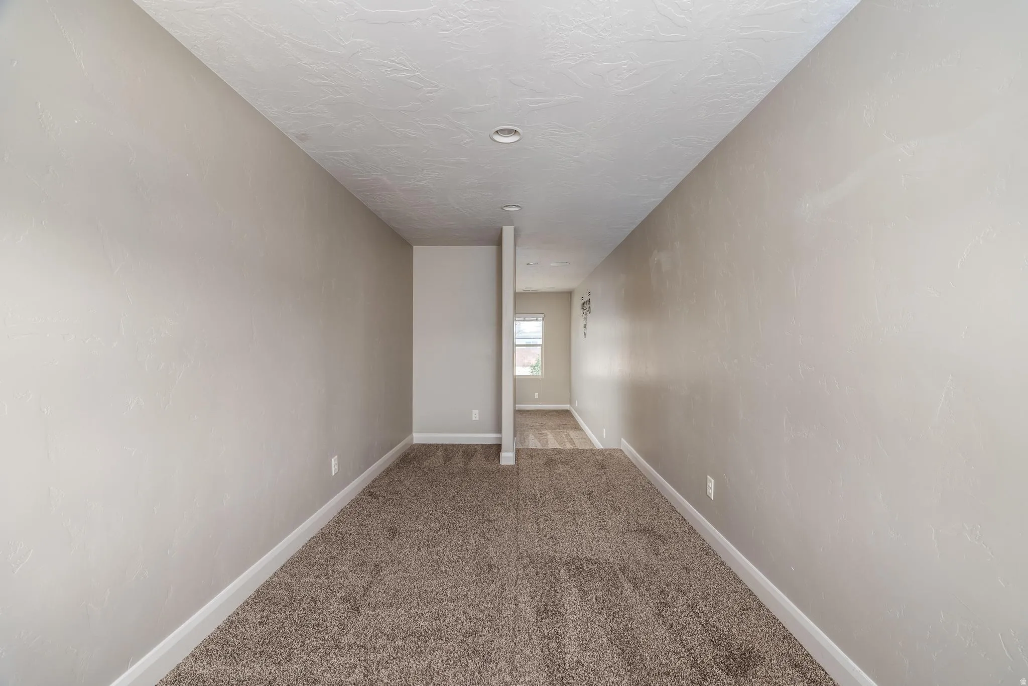 Neutral-toned walls complement a brown carpeted floor