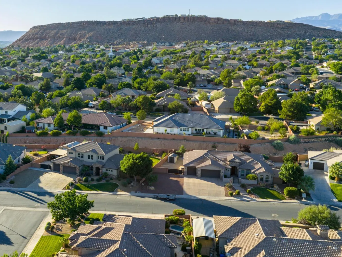 Expansive neighborhood featuring numerous residential properties with varied architectural styles, mature landscaping, and paved streets
