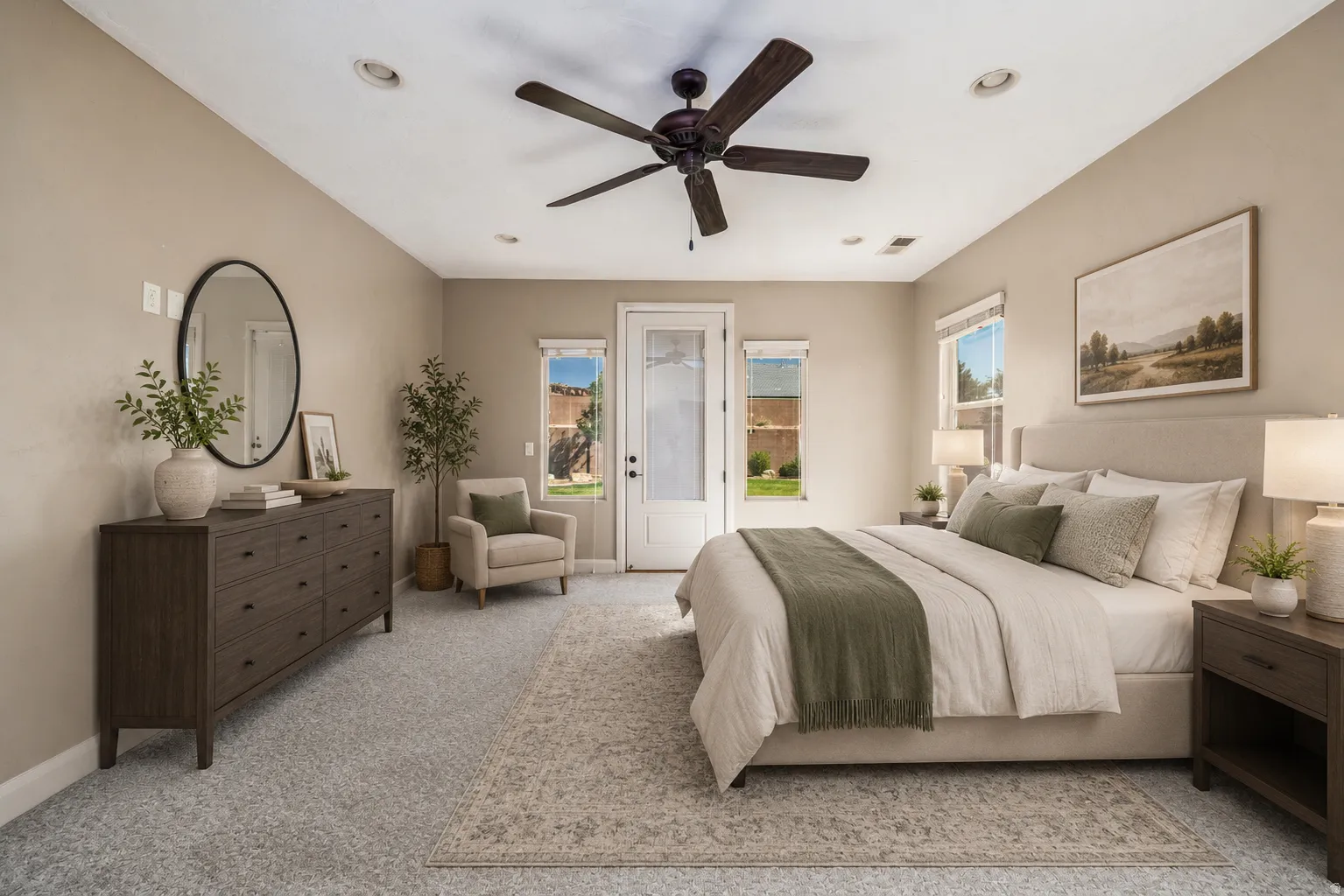 Spacious room featuring neutral wall tones, recessed lighting, a ceiling fan, a full-light exterior door, and multiple windows for natural illumination