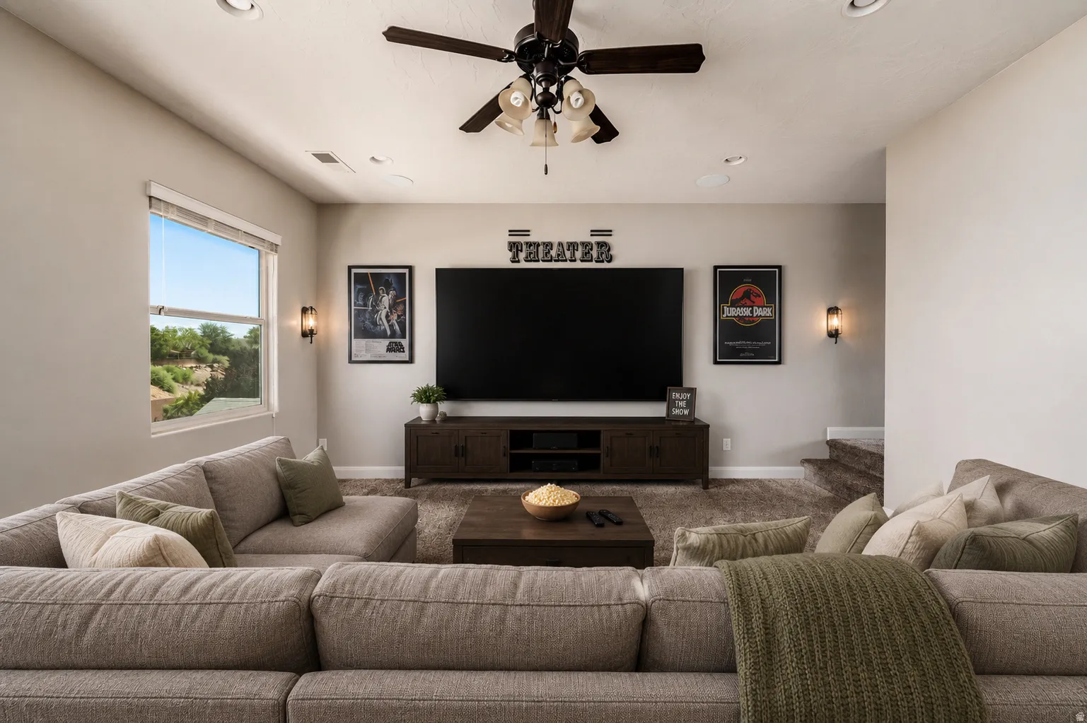 Media room featuring recessed lighting, a ceiling fan, sconce lighting, and a window