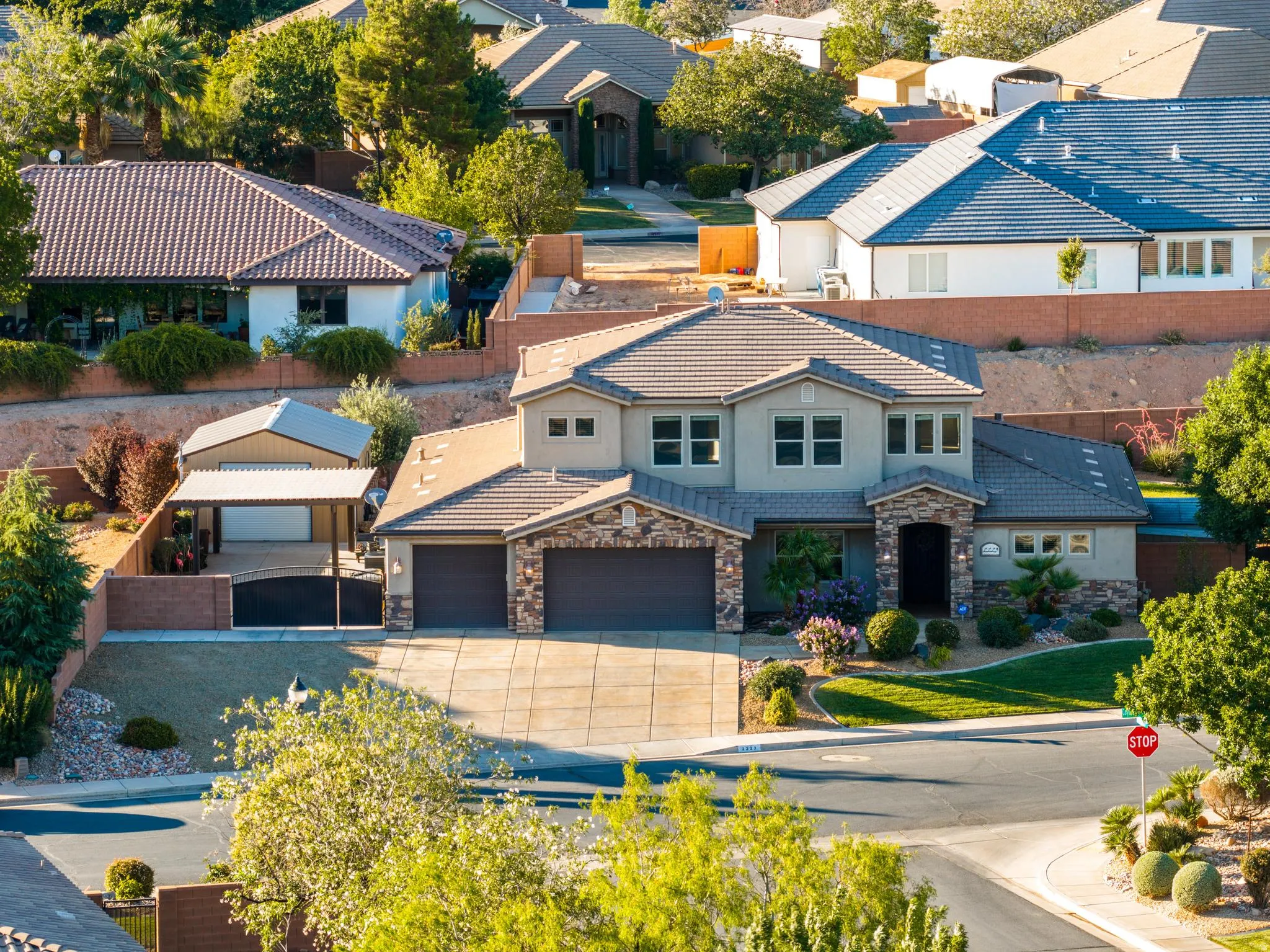 Stucco exterior with stone accents and a multi-level roofline