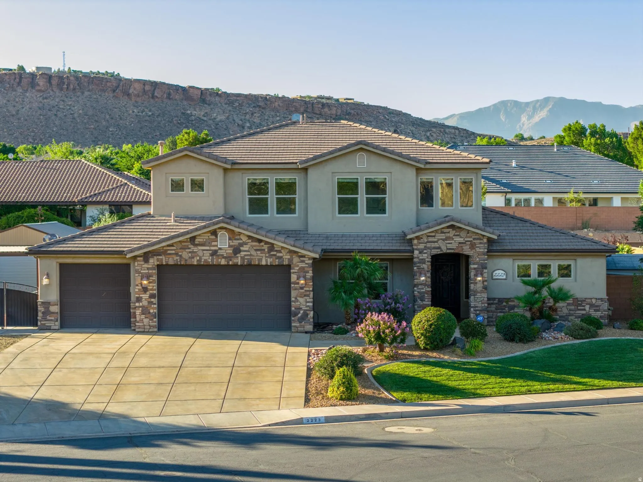 Stucco exterior with stone accents and a tile roof