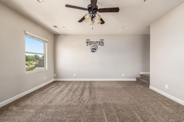 Spacious room featuring neutral carpeting and light gray walls