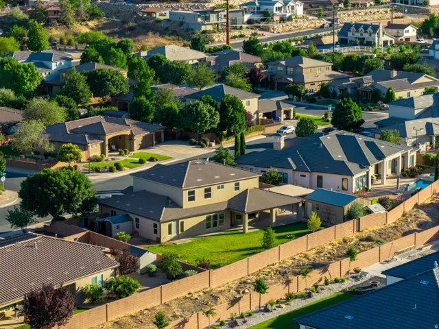Residential properties with varied architectural styles situated among desert hills