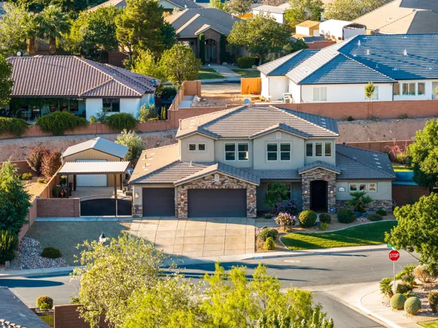 Stucco exterior with stone accents and a multi-level roofline