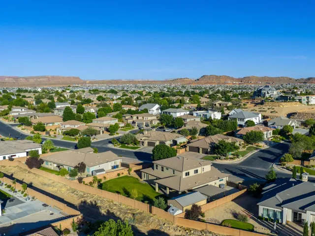 Expansive residential development featuring paved streets, mature landscaping, and diverse architectural styles