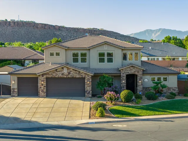 Stucco exterior with stone accents and a tile roof