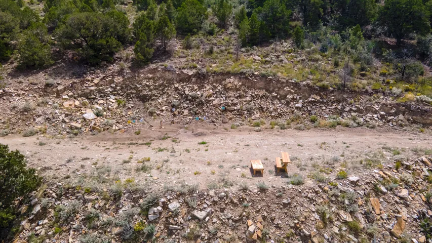 Expansive undeveloped terrain with varying elevations, natural rock formations, and scattered native vegetation