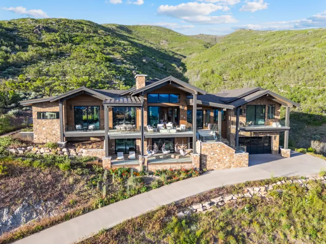 Mountain modern residence featuring extensive stone and wood siding