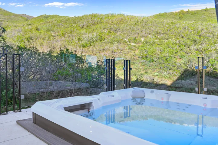 Outdoor spa with a clear water surface