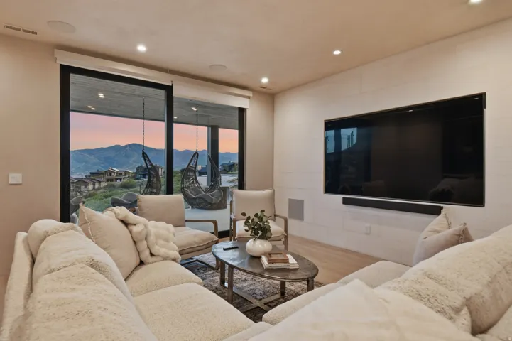 Sliding glass doors opening to a scenic mountain backdrop