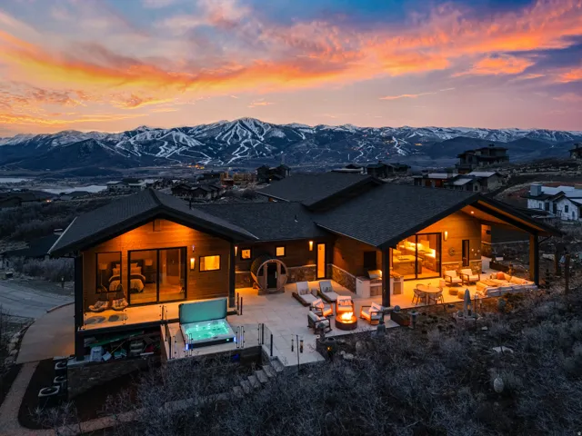 Contemporary-style residence with a large exterior patio featuring a built-in fire pit, covered outdoor living space, and a hot tub