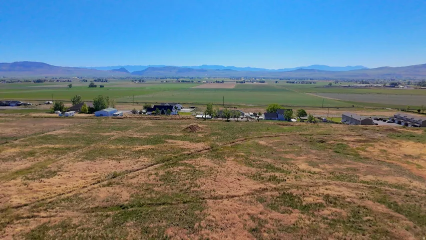 Expansive undeveloped land with a distant mountainous backdrop