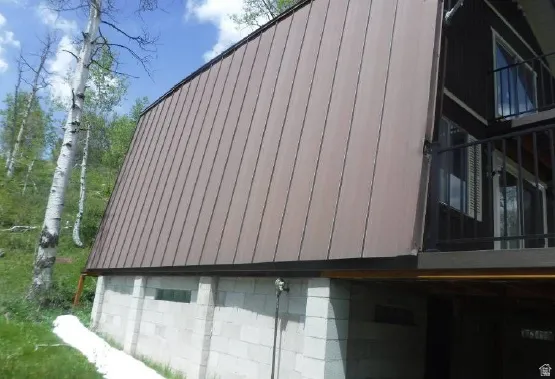 A-frame structure featuring a brown metal roof