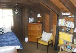 Room featuring exposed wood beam ceilings and wood-paneled walls