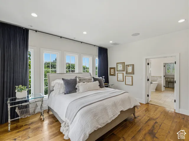 Bedroom with extensive natural hardwood flooring and recessed ceiling lighting