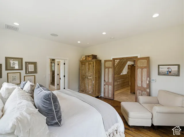 Spacious room featuring wood-finish flooring, recessed lighting, and a neutral color palette