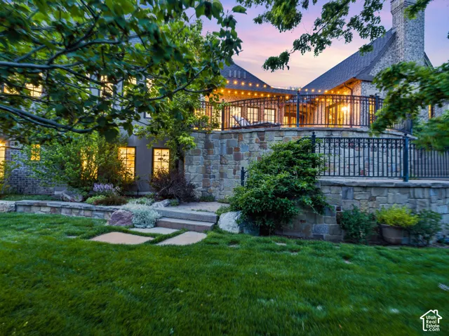 Expansive terraced yard featuring a manicured lawn and stone retaining walls