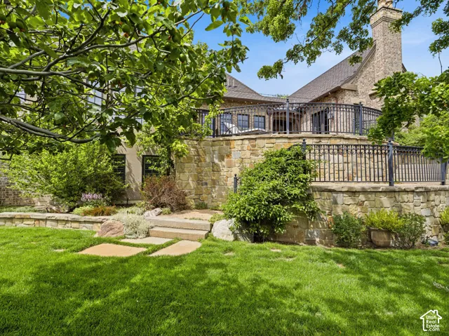 Stone-clad exterior featuring a multi-level terraced design with wrought iron railings
