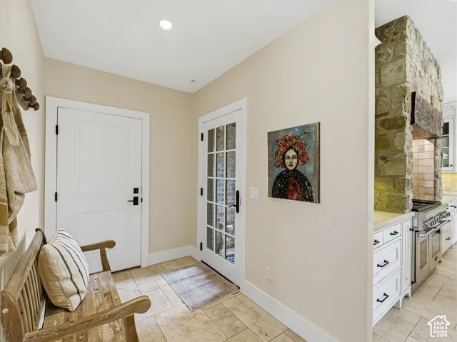 Entryway featuring tile flooring, recessed lighting, a solid white door, and a French door with multiple glass panes