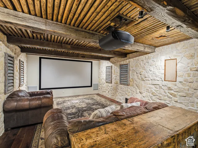 Dedicated media room featuring a large projection screen and ceiling-mounted projector