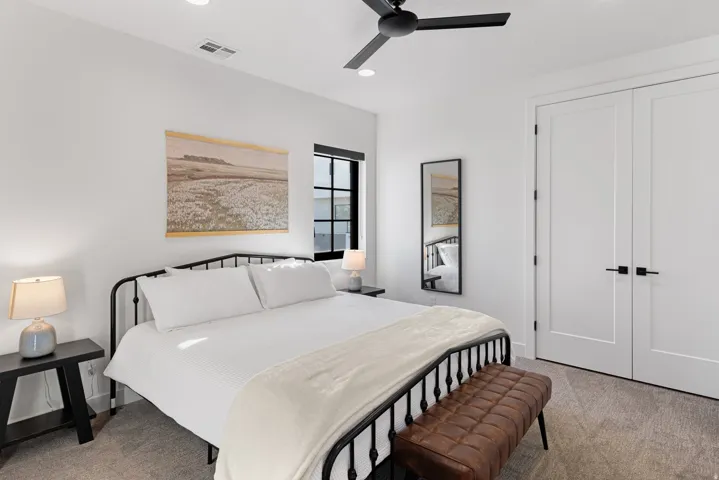 Neutral interior featuring a matte black ceiling fan, recessed lighting, and a window with black trim