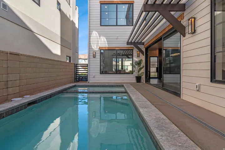 Private courtyard pool with integrated spa and dark tile coping