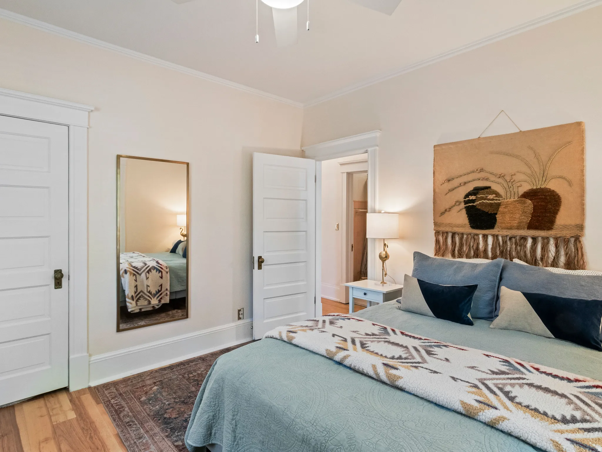 Hardwood flooring complements the neutral wall color and white trim