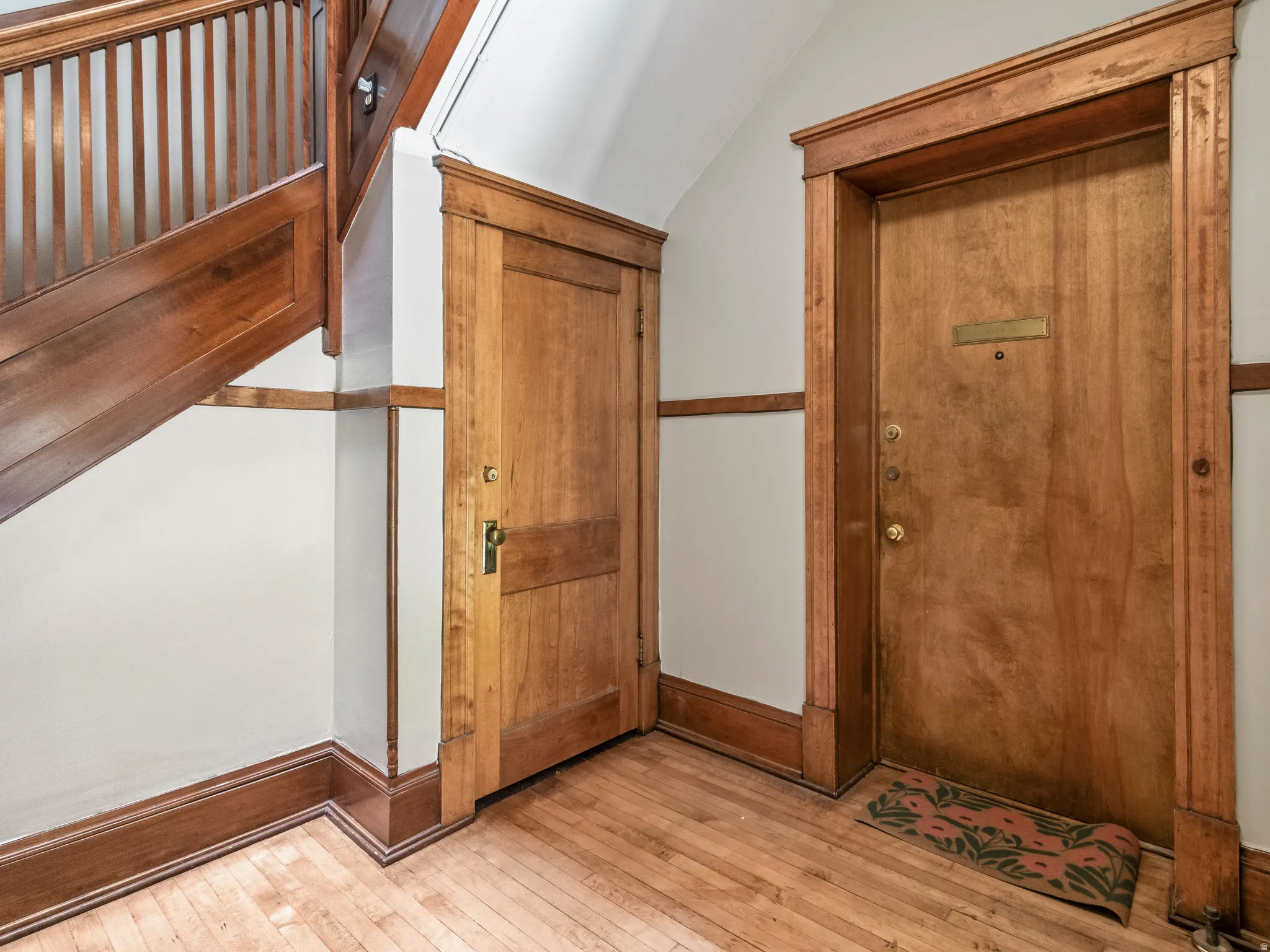 Natural wood-finish staircase with balusters and handrail