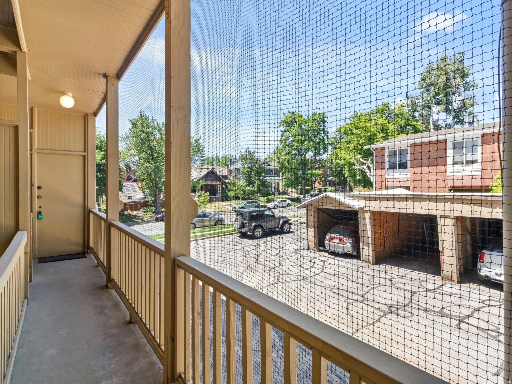 Outdoor balcony with beige railing and overhead lighting