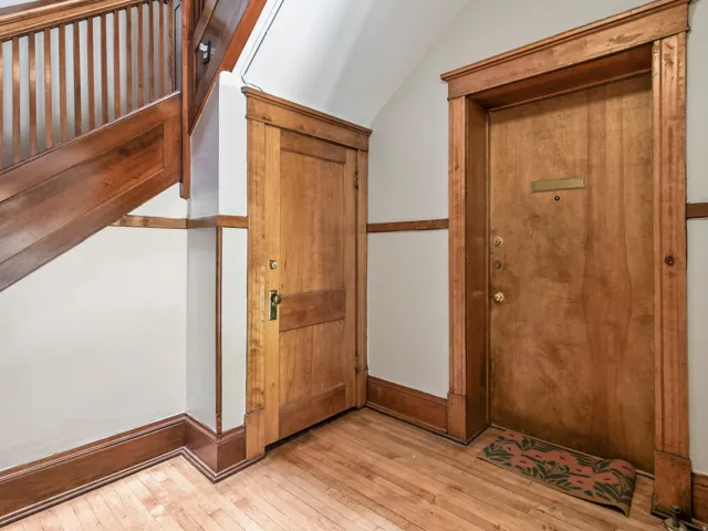 Natural wood-finish staircase with balusters and handrail