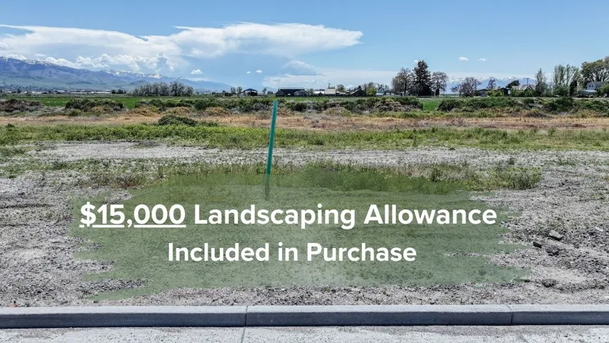 Expansive buildable lot featuring a newly installed curb, level ground, and mountain scenery