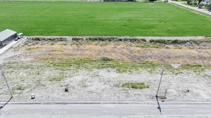 Expansive undeveloped lot featuring street frontage, utility pedestals, and a level building area