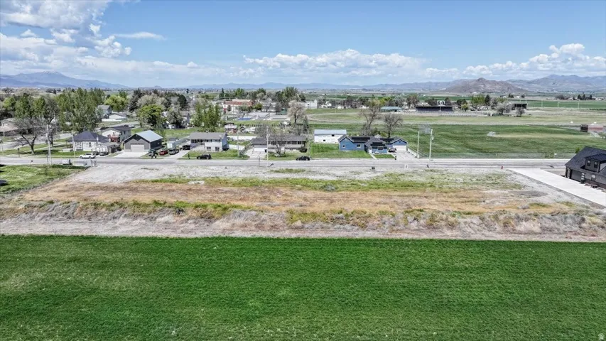 Expansive land parcel featuring a flat topography, established roadways, and a surrounding residential area