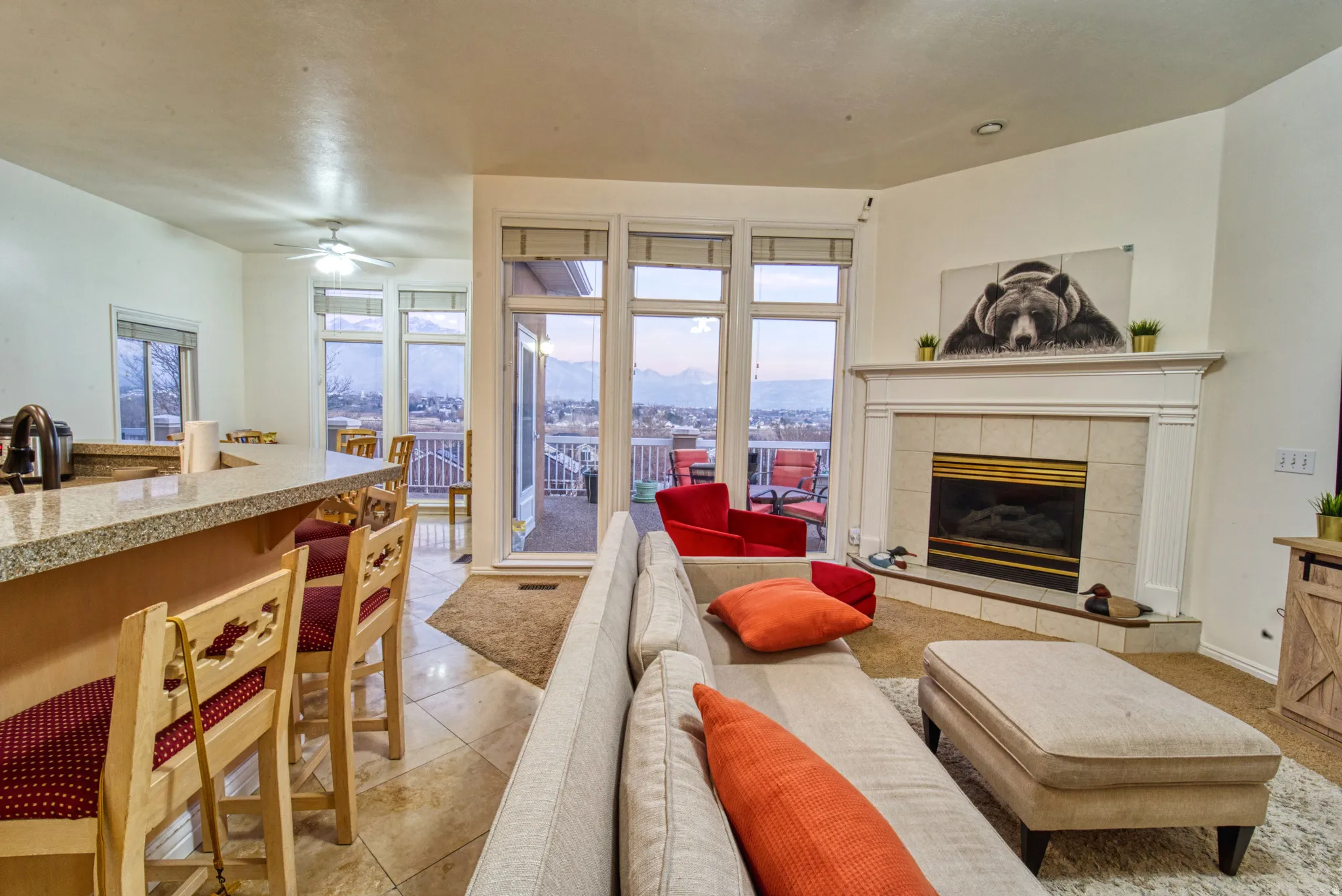 Living area featuring a gas fireplace with a light-colored tile surround and white mantel